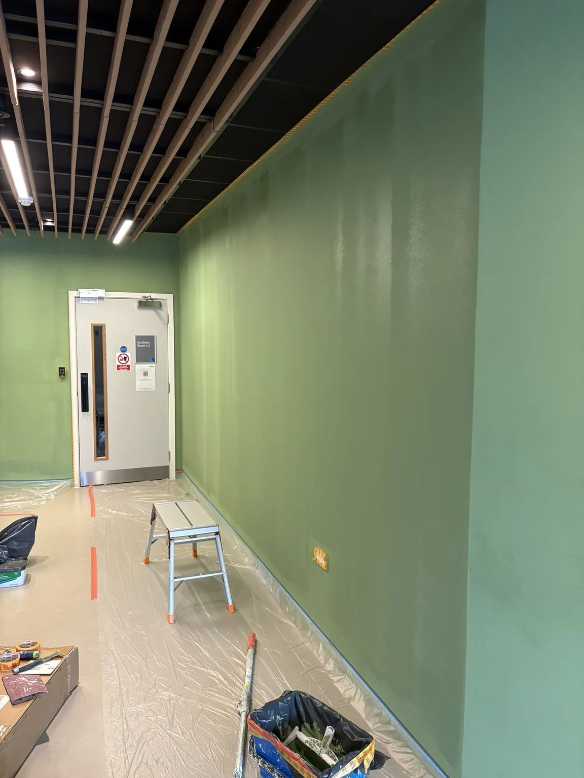 Commercial green feature walls being redecorated during an East London education project