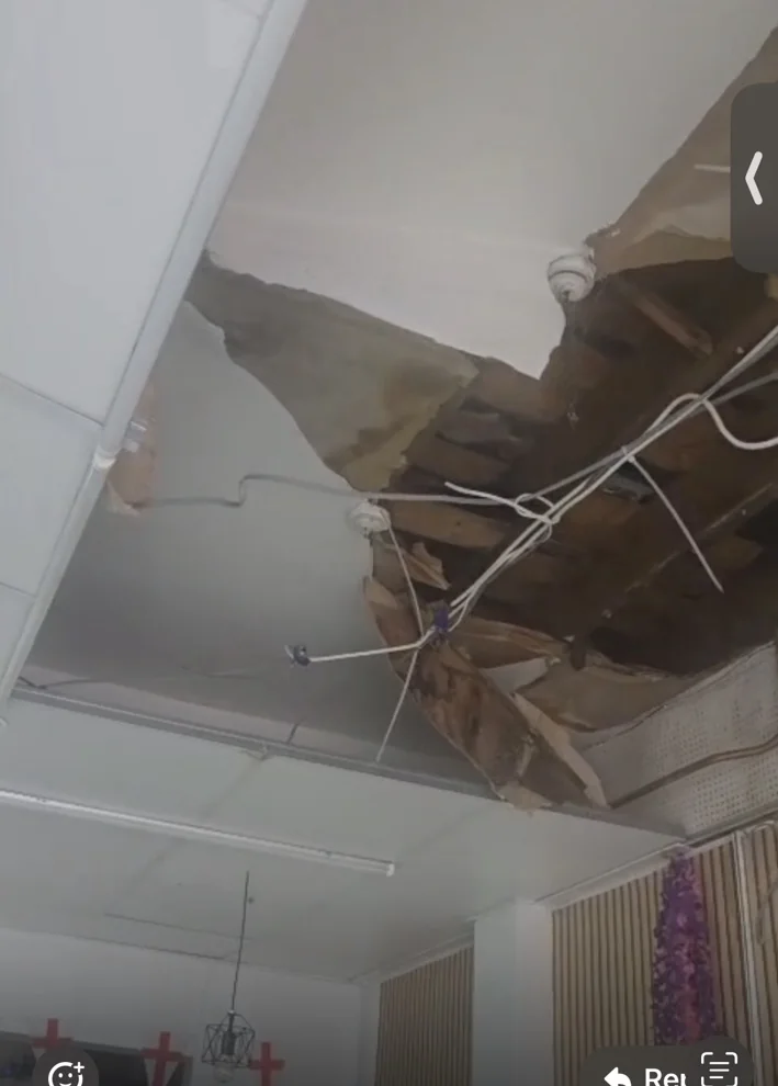 Close view of collapsed suspended ceiling damage requiring urgent commercial repair